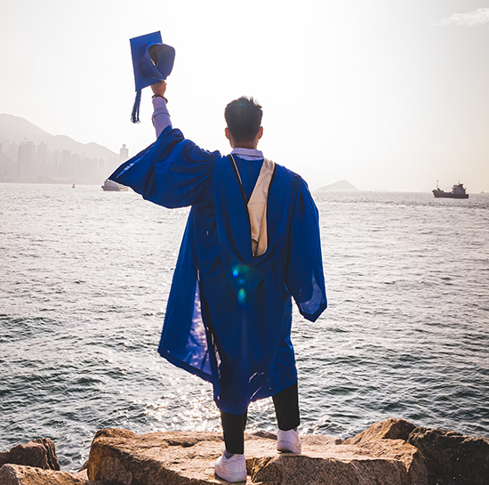 Happy graduate celebrating debt freedom